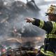 fire fighter wearing black and yellow uniform pointing for 70573